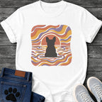 French Bulldog t-shirt with Frenchie silhouette seen from behind on a baseline inside a rounded square, swirling wavy lines filling the frame in terracotta gold and soft purple, terracotta sun arc rising behind the head, distressed texture, no text psychedelic art graphic