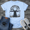 French Bulldog t-shirt with Frenchie silhouette seen from behind in ink wash style, sitting in brushstroke cattails and grass, dark watercolor horizon band, loose concentric ink arch above, single dark ink tone, no text sumi-e art graphic
