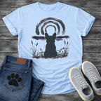 French Bulldog t-shirt with Frenchie silhouette seen from behind in ink wash style, sitting in brushstroke cattails and grass, dark watercolor horizon band, loose concentric ink arch above, single dark ink tone, no text sumi-e art graphic
