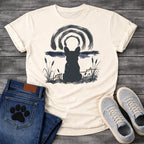 French Bulldog t-shirt with Frenchie silhouette seen from behind in ink wash style, sitting in brushstroke cattails and grass, dark watercolor horizon band, loose concentric ink arch above, single dark ink tone, no text sumi-e art graphic
