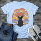 French Bulldog t-shirt with Frenchie silhouette seen from behind centered in a layered organic landscape of terracotta gold and soft purple flowing forms, color rippling in a water reflection below, no text warm painterly art graphic