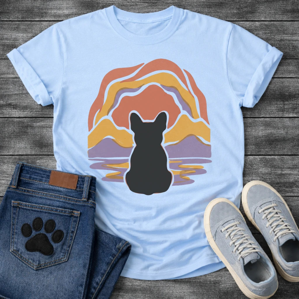 French Bulldog t-shirt with Frenchie silhouette seen from behind centered in a layered organic landscape of terracotta gold and soft purple flowing forms, color rippling in a water reflection below, no text warm painterly art graphic