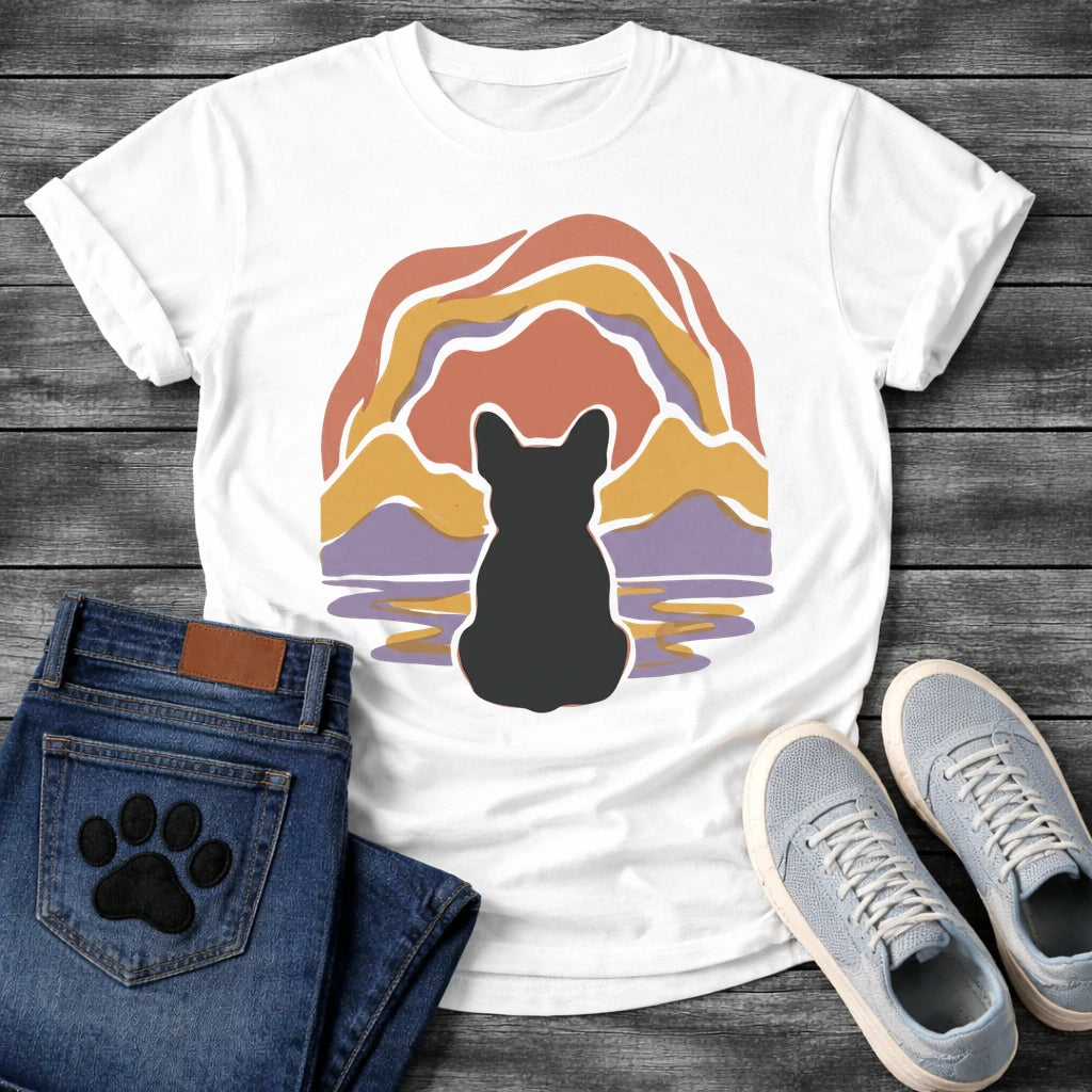 French Bulldog t-shirt with Frenchie silhouette seen from behind centered in a layered organic landscape of terracotta gold and soft purple flowing forms, color rippling in a water reflection below, no text warm painterly art graphic