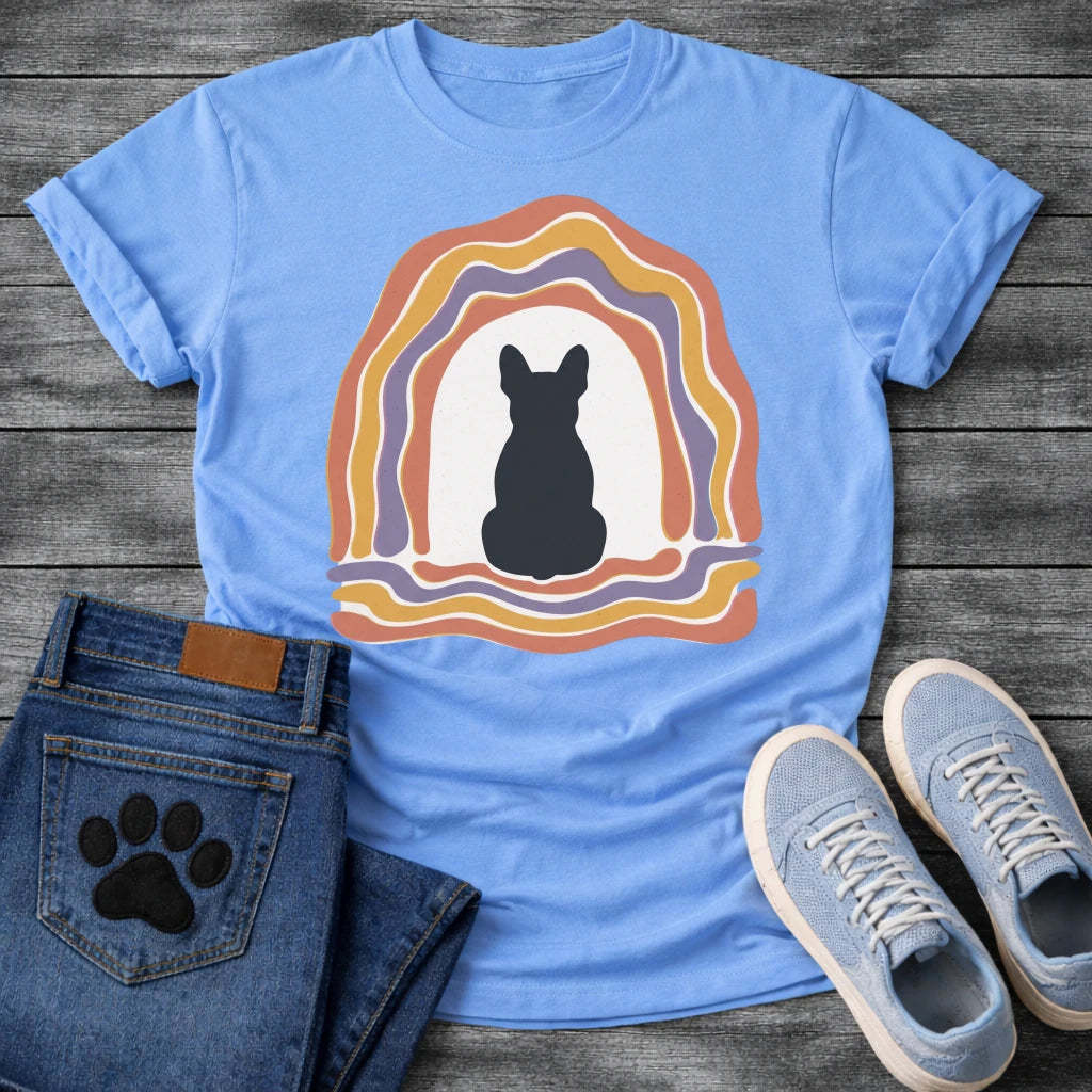 Carolina BlueFrench Bulldog t-shirt with Frenchie silhouette seen from behind centered in a cream open space, surrounded by layered organic concentric arch in terracotta gold and soft purple, wavy lines trailing below, no text soft boho art graphic
