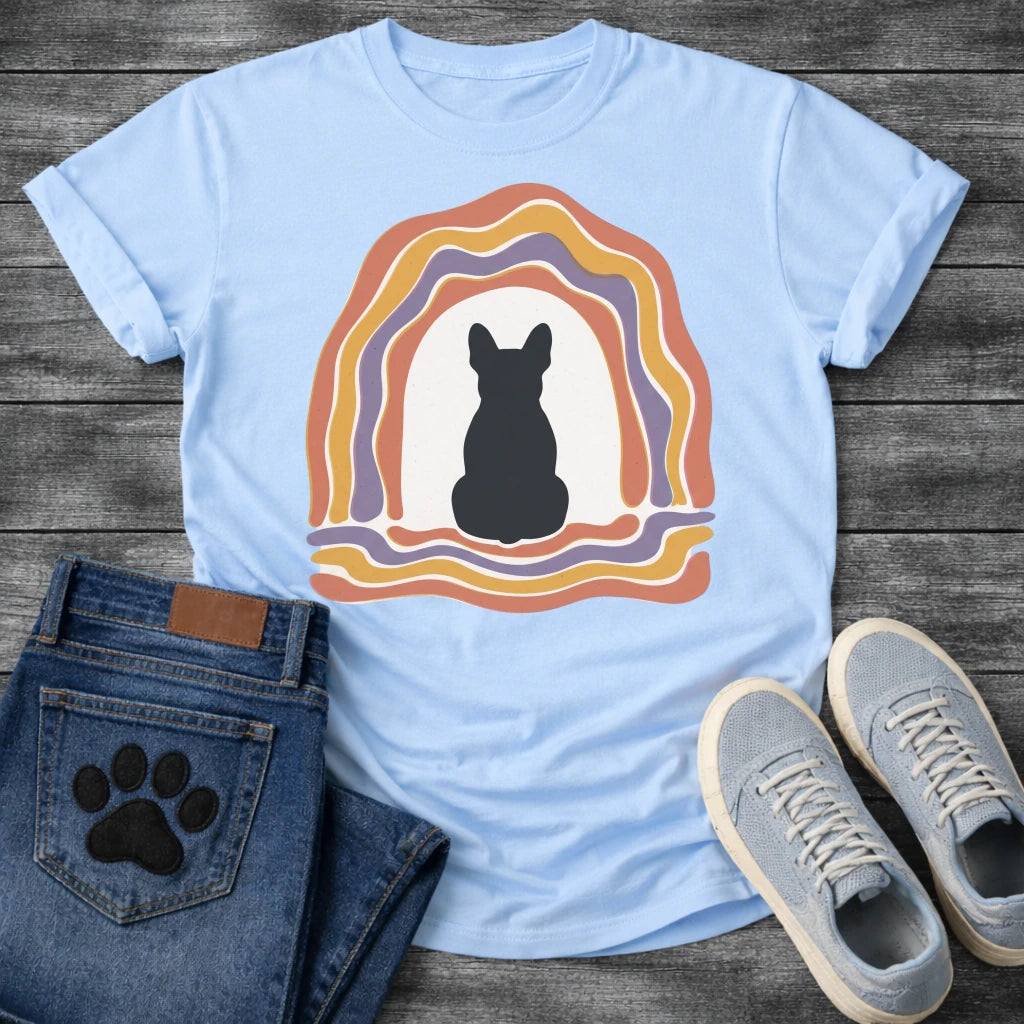 French Bulldog t-shirt with Frenchie silhouette seen from behind centered in a cream open space, surrounded by layered organic concentric arch in terracotta gold and soft purple, wavy lines trailing below, no text soft boho art graphic
