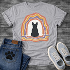 French Bulldog t-shirt with Frenchie silhouette seen from behind centered in a cream open space, surrounded by layered organic concentric arch in terracotta gold and soft purple, wavy lines trailing below, no text soft boho art graphic

