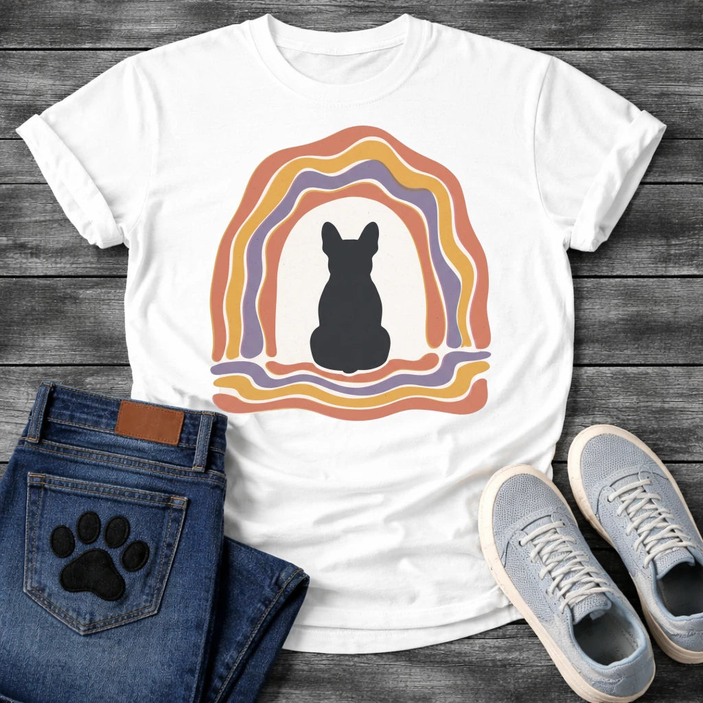 French Bulldog t-shirt with Frenchie silhouette seen from behind centered in a cream open space, surrounded by layered organic concentric arch in terracotta gold and soft purple, wavy lines trailing below, no text soft boho art graphic
