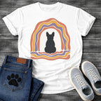 French Bulldog t-shirt with Frenchie silhouette seen from behind centered in a cream open space, surrounded by layered organic concentric arch in terracotta gold and soft purple, wavy lines trailing below, no text soft boho art graphic
