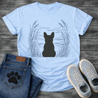French Bulldog t-shirt with Frenchie silhouette seen from behind centered in a wide open navy line art botanical scene, tall reeds and cattails sweeping in from both sides, rippling water and distant mountain horizon ahead, no text refined nature illustration