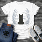 French Bulldog t-shirt with Frenchie silhouette seen from behind centered in a wide open navy line art botanical scene, tall reeds and cattails sweeping in from both sides, rippling water and distant mountain horizon ahead, no text refined nature illustration