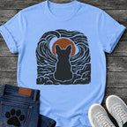 French Bulldog t-shirt with Frenchie silhouette seen from behind sitting on cracked rock, bold swirling woodcut style sky in black and cream surrounding a terracotta moon, heavy linocut print texture throughout, no text dramatic art graphic
