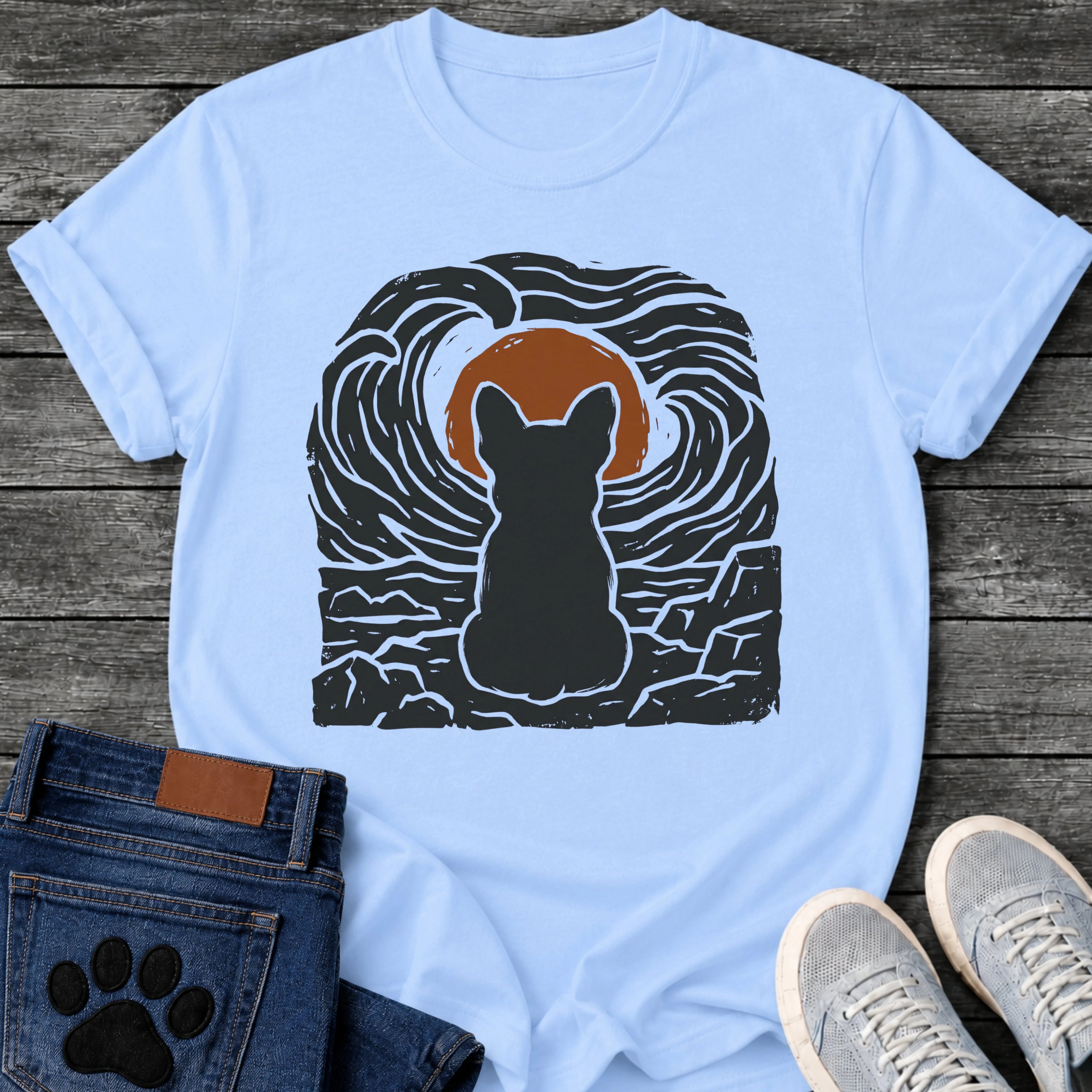French Bulldog t-shirt with Frenchie silhouette seen from behind sitting on cracked rock, bold swirling woodcut style sky in black and cream surrounding a terracotta moon, heavy linocut print texture throughout, no text dramatic art graphic

