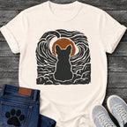 NaturalFrench Bulldog t-shirt with Frenchie silhouette seen from behind sitting on cracked rock, bold swirling woodcut style sky in black and cream surrounding a terracotta moon, heavy linocut print texture throughout, no text dramatic art graphic
