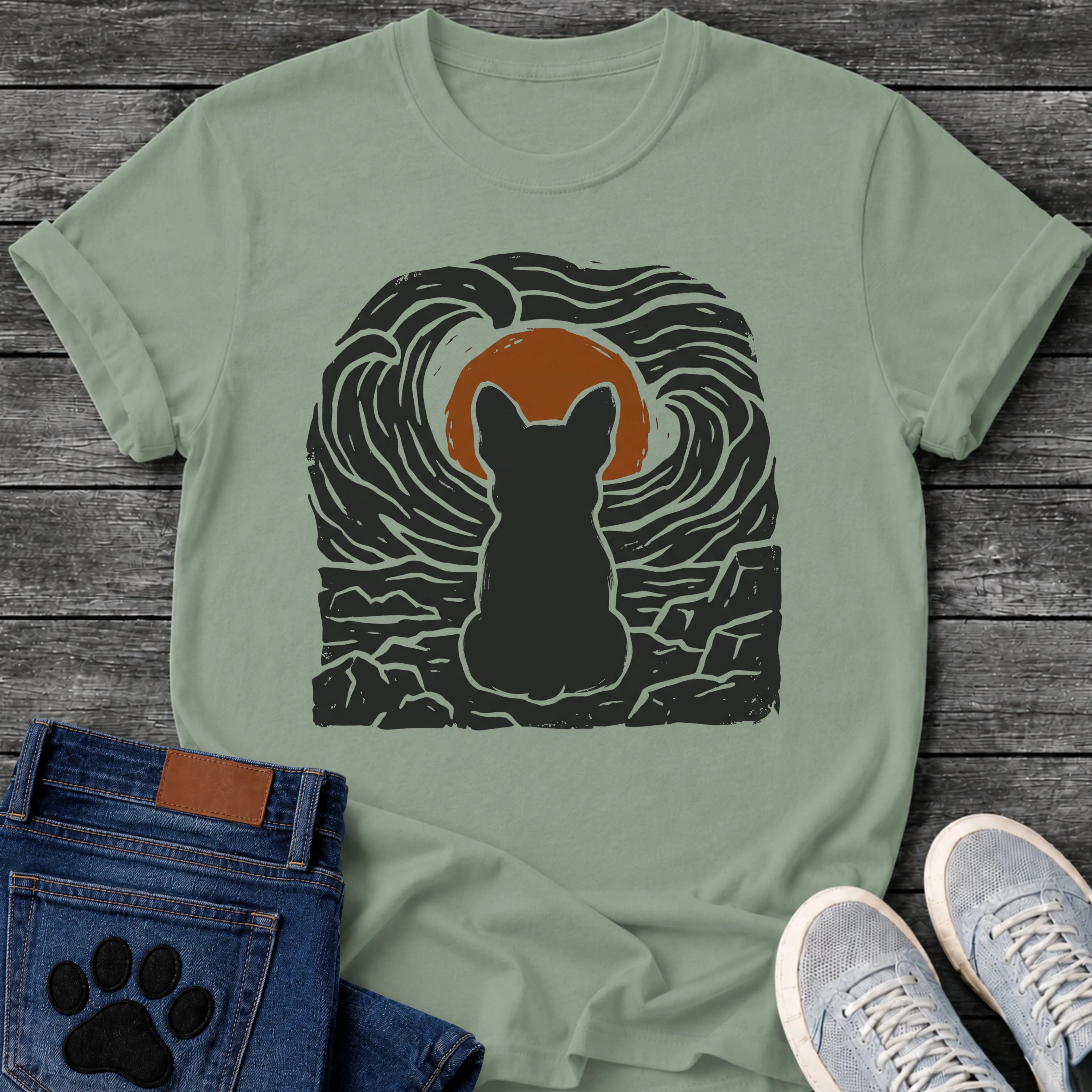 French Bulldog t-shirt with Frenchie silhouette seen from behind sitting on cracked rock, bold swirling woodcut style sky in black and cream surrounding a terracotta moon, heavy linocut print texture throughout, no text dramatic art graphic
