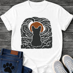 French Bulldog t-shirt with Frenchie silhouette seen from behind sitting on cracked rock, bold swirling woodcut style sky in black and cream surrounding a terracotta moon, heavy linocut print texture throughout, no text dramatic art graphic
