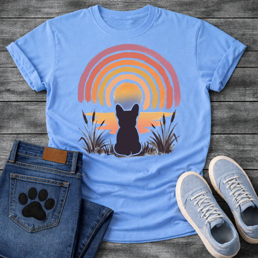 French Bulldog t-shirt with Frenchie silhouette seen from behind sitting in ink wash grass and cattails, soft watercolor sunset glow below, concentric brushstroke rainbow arch above in lavender coral orange and gold, no text painterly watercolor art graphic