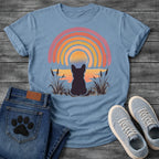 French Bulldog t-shirt with Frenchie silhouette seen from behind sitting in ink wash grass and cattails, soft watercolor sunset glow below, concentric brushstroke rainbow arch above in lavender coral orange and gold, no text painterly watercolor art graphic