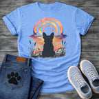 French Bulldog t-shirt with Frenchie silhouette seen from behind in ink wash cattails and grass, full watercolor sunset in coral gold and deep purple behind, loose concentric brushstroke rainbow arch above, no text painterly watercolor art graphic