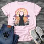 French Bulldog t-shirt with Frenchie silhouette seen from behind in ink wash cattails and grass, full watercolor sunset in coral gold and deep purple behind, loose concentric brushstroke rainbow arch above, no text painterly watercolor art graphic