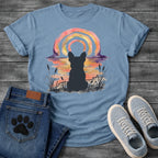 French Bulldog t-shirt with Frenchie silhouette seen from behind in ink wash cattails and grass, full watercolor sunset in coral gold and deep purple behind, loose concentric brushstroke rainbow arch above, no text painterly watercolor art graphic