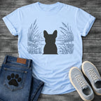 French Bulldog t-shirt with Frenchie silhouette seen from behind centered in a detailed navy line art botanical scene, cattails and tall reeds on either side, still water and distant shoreline ahead, no text refined nature illustration graphic
