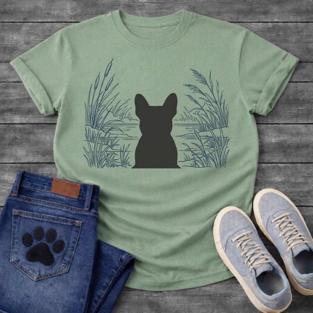 French Bulldog t-shirt with Frenchie silhouette seen from behind centered in a detailed navy line art botanical scene, cattails and tall reeds on either side, still water and distant shoreline ahead, no text refined nature illustration graphic
