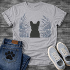 French Bulldog t-shirt with Frenchie silhouette seen from behind centered in a detailed navy line art botanical scene, cattails and tall reeds on either side, still water and distant shoreline ahead, no text refined nature illustration graphic
