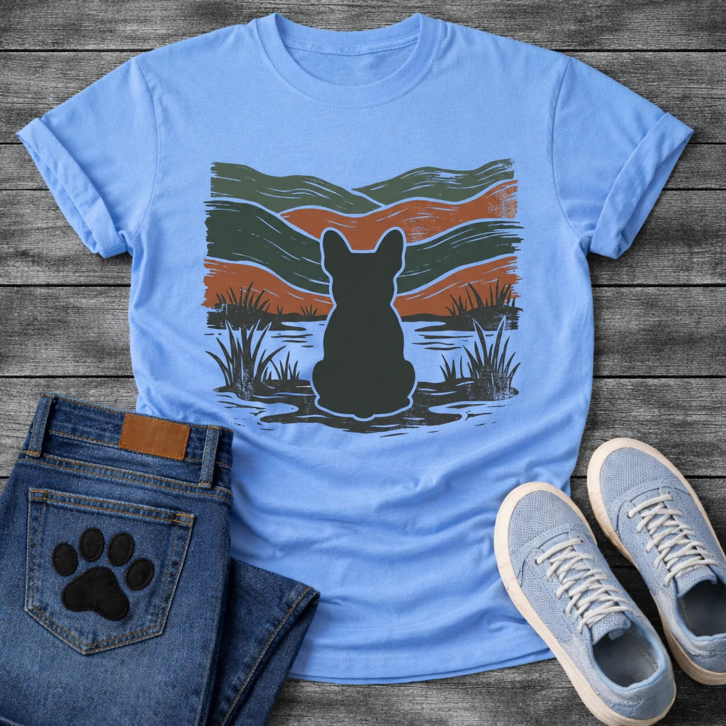 French Bulldog t-shirt with Frenchie silhouette seen from behind with cream outline sitting in grass and shallow water, bold woodcut style wavy landscape in forest green and terracotta behind, heavy distressed texture throughout, no text earthy art graphic