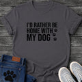 Bold block letter graphic tee design reading "I'd Rather Be Home With My Dog," with three paw prints trailing down the right side.
