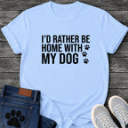 Bold block letter graphic tee design reading "I'd Rather Be Home With My Dog," with three paw prints trailing down the right side.