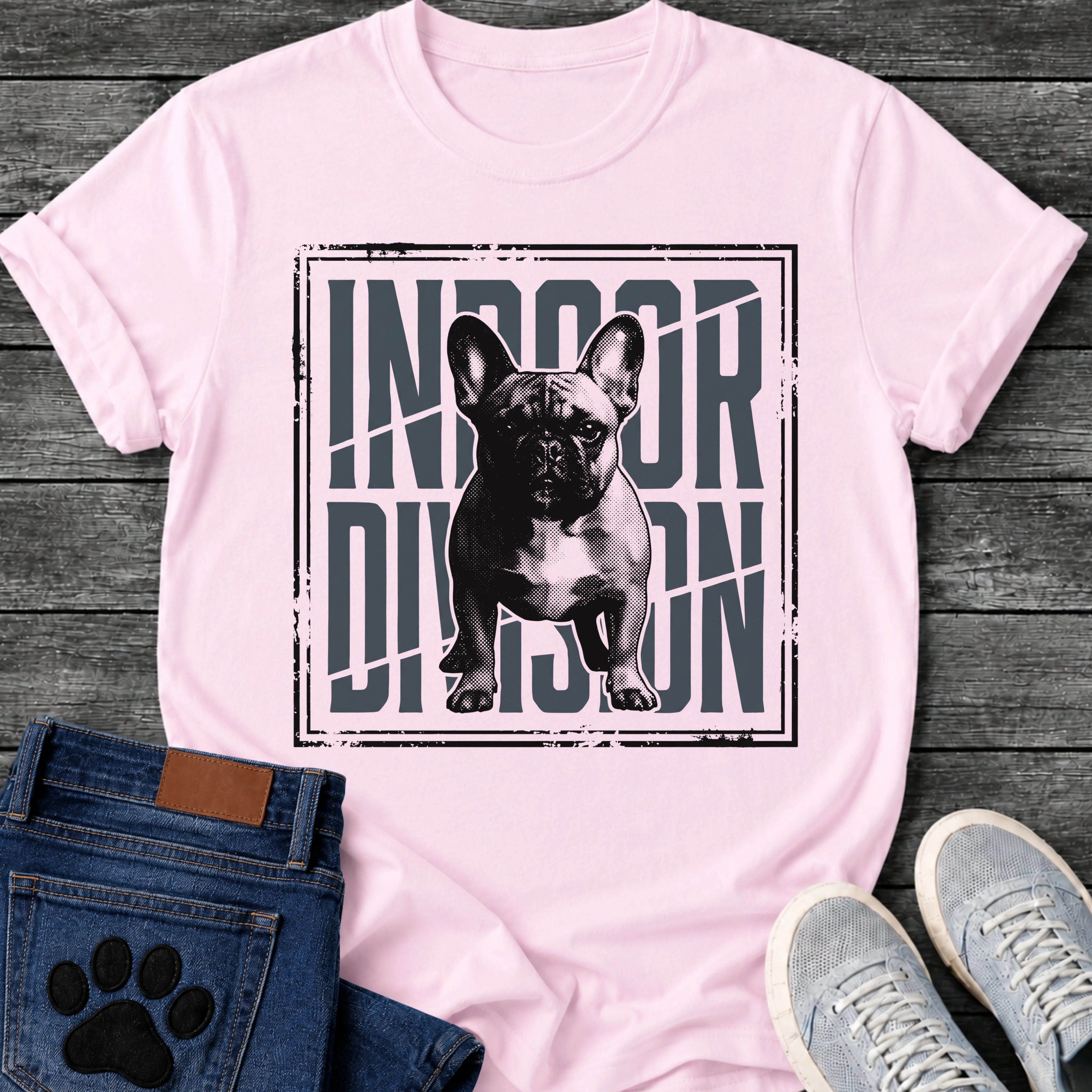 French Bulldog t-shirt with halftone Frenchie standing full body facing forward, oversized condensed slate blue text reading Indoor Division behind the portrait, diagonal slash detail, heavy distressed double border frame, black and slate two-color graphic
