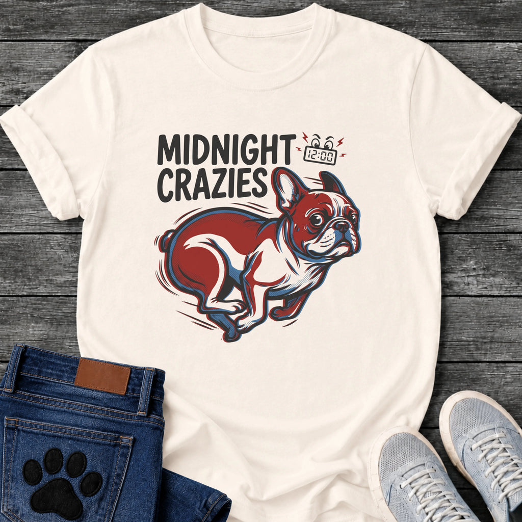 French Bulldog t-shirt with bold retro comic text reading Midnight Crazies upper left, animated alarmed clock showing 12:00 with lightning bolts and cartoon eyes, large red and blue halftone Frenchie running at full speed, speed lines throughout