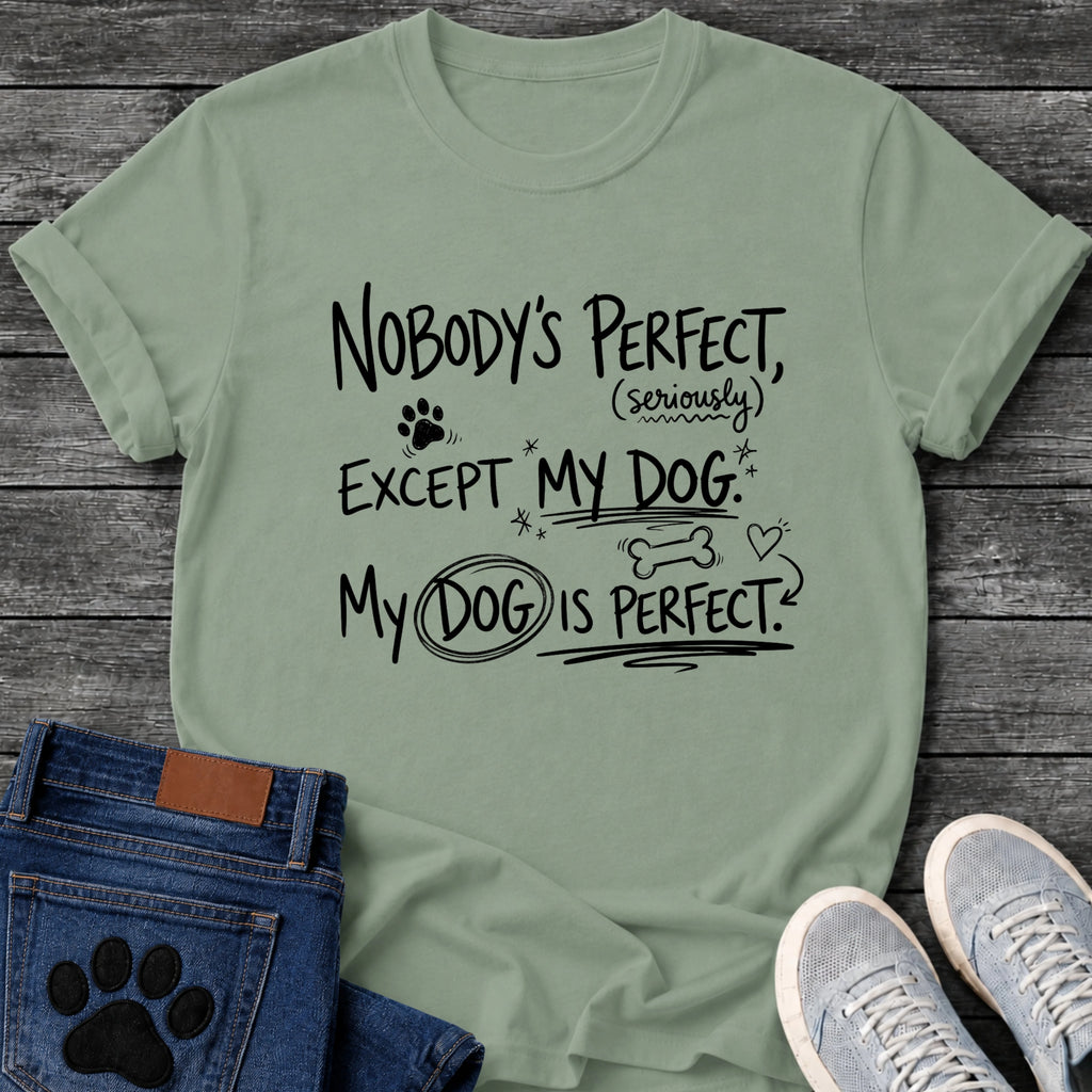 Hand drawn graphic tee design reading "Nobody's Perfect, Seriously, Except My Dog. My Dog Is Perfect," with doodled paw prints, stars, a bone, and a heart.
