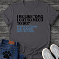 Bold two tone graphic tee design reading "I Be Like 'OMG I Got So Much To Do!' Then Lay Down and Cuddle With My Dog" in black and blue lettering.