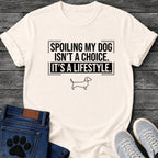 Bold framed graphic tee design reading "Spoiling My Dog Isn't a Choice, It's a Lifestyle," with a Dachshund outline below the text.