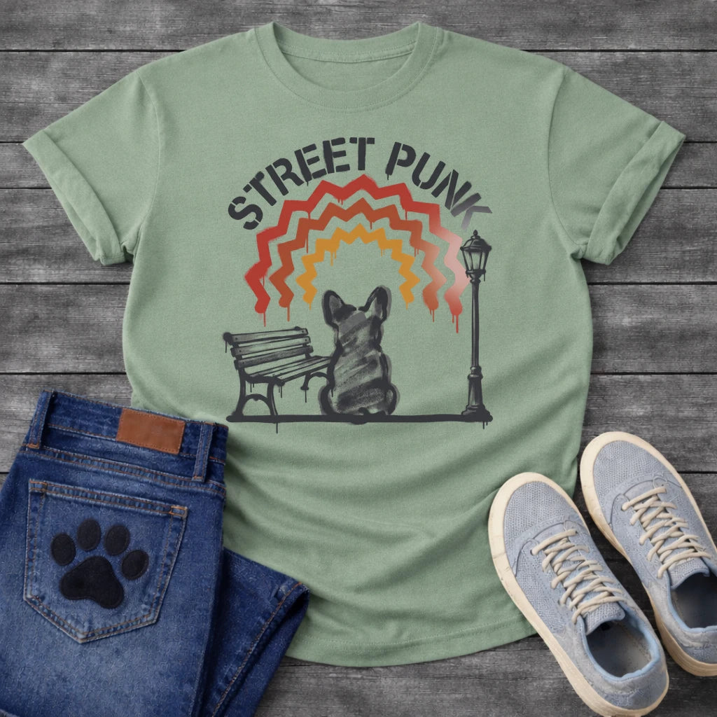 French Bulldog t-shirt with stencil arched text reading Street Punk above a spray paint scene of a Frenchie sitting on a park bench beside a street lamp, zigzag spray paint rainbow in red terracotta and gold with drips, urban street art graphic