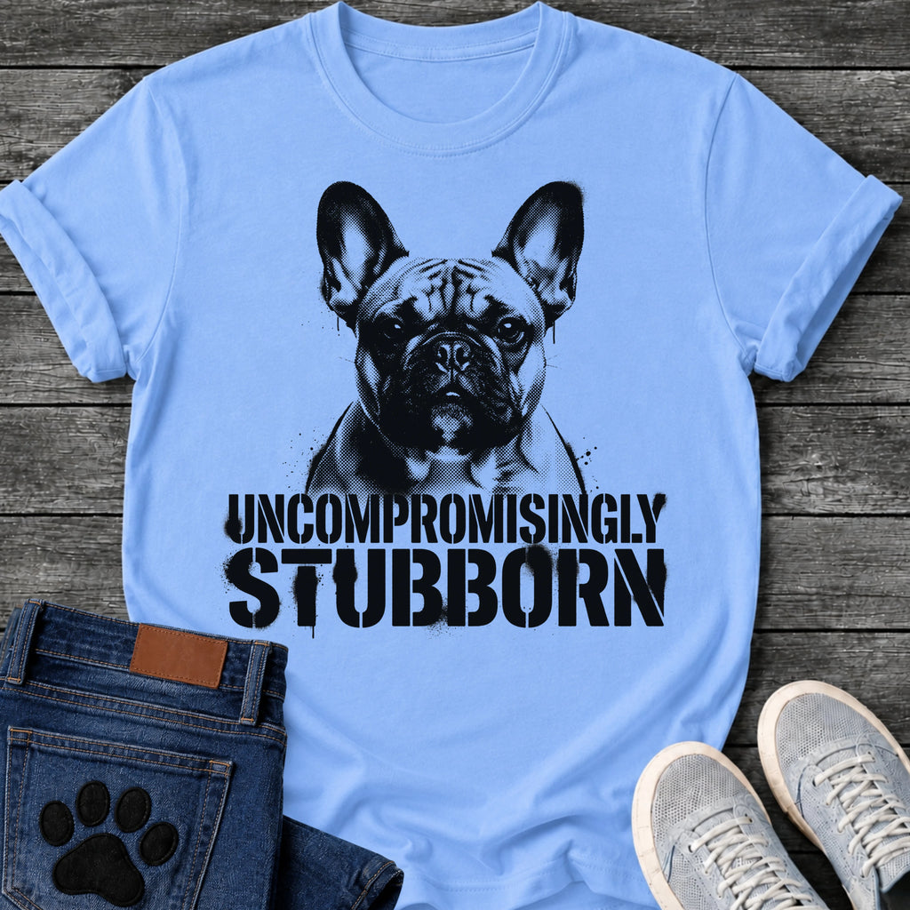 French Bulldog t-shirt with high contrast halftone Frenchie portrait facing forward with ink splatter drip details, bold oversized stencil text below reading Uncompromisingly Stubborn, single black ink graphic with serious streetwear energy
