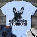 French Bulldog t-shirt with high contrast halftone Frenchie portrait facing forward with ink splatter drip details, bold oversized stencil text below reading Uncompromisingly Stubborn, single black ink graphic with serious streetwear energy

