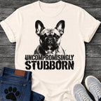 French Bulldog t-shirt with high contrast halftone Frenchie portrait facing forward with ink splatter drip details, bold oversized stencil text below reading Uncompromisingly Stubborn, single black ink graphic with serious streetwear energy
