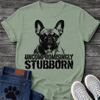 French Bulldog t-shirt with high contrast halftone Frenchie portrait facing forward with ink splatter drip details, bold oversized stencil text below reading Uncompromisingly Stubborn, single black ink graphic with serious streetwear energy
