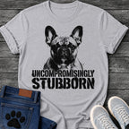 French Bulldog t-shirt with high contrast halftone Frenchie portrait facing forward with ink splatter drip details, bold oversized stencil text below reading Uncompromisingly Stubborn, single black ink graphic with serious streetwear energy
