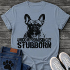 French Bulldog t-shirt with high contrast halftone Frenchie portrait facing forward with ink splatter drip details, bold oversized stencil text below reading Uncompromisingly Stubborn, single black ink graphic with serious streetwear energy
