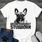French Bulldog t-shirt with high contrast halftone Frenchie portrait facing forward with ink splatter drip details, bold oversized stencil text below reading Uncompromisingly Stubborn, single black ink graphic with serious streetwear energy
